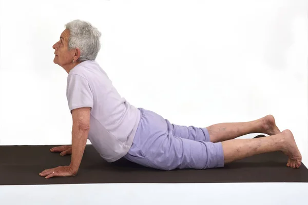 Senior woman doing yoga, isolated