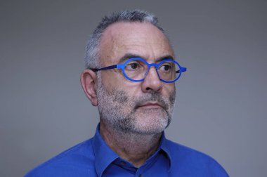 Orta yaşlı adam mavi gömlek ve gözlük