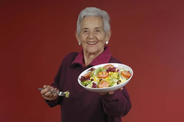 Senior woman wiht salad — Stock Photo, Image