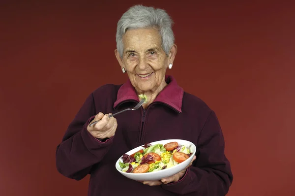 Senior woman witf salad — Stock Photo, Image