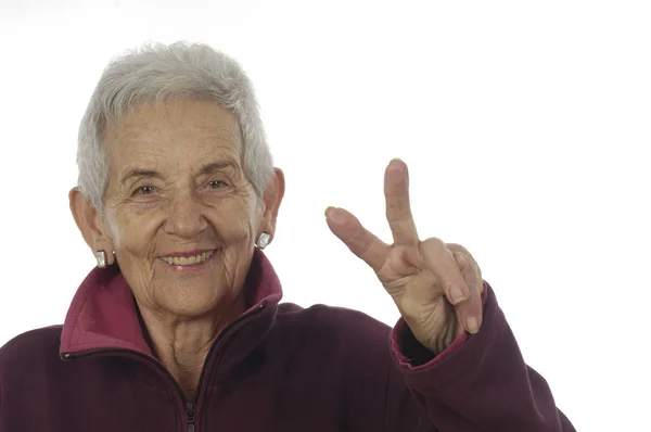 Senior woman sing V — Stock Photo, Image