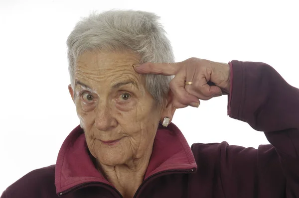 Старша жінка з пальцем на голові — стокове фото