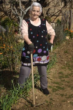 Old woman working in her garden