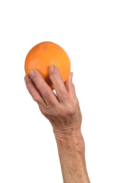 Hand of senior woman and orange isolated on white — Stock Photo, Image