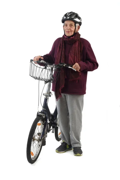 Mulher idosa em uma bicicleta em um fundo branco — Fotografia de Stock