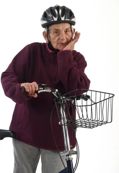 Elderly woman on a bicycle on a white background — Stock Photo, Image