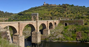Roman bridge over the Tajo river in Alcantara, Caceres province, clipart