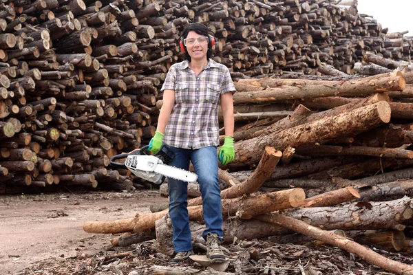 portrait of a woman with a chainsaw