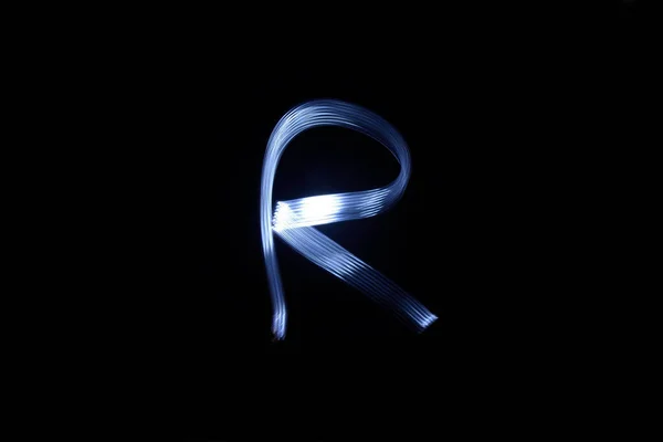 Paint with light on black background letter R — Stock Photo, Image