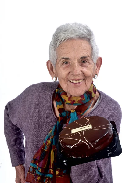 Senior woman playing cake;on white — Stock Photo, Image