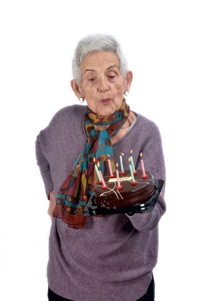 Senior woman playing cake;on white — Stock Photo, Image