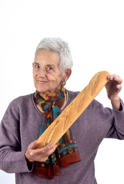 Mujer mayor comiendo pan sobre fondo blanco —  Fotos de Stock