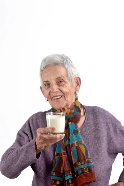 Senior woman drinking milk on white background — Stock Photo, Image