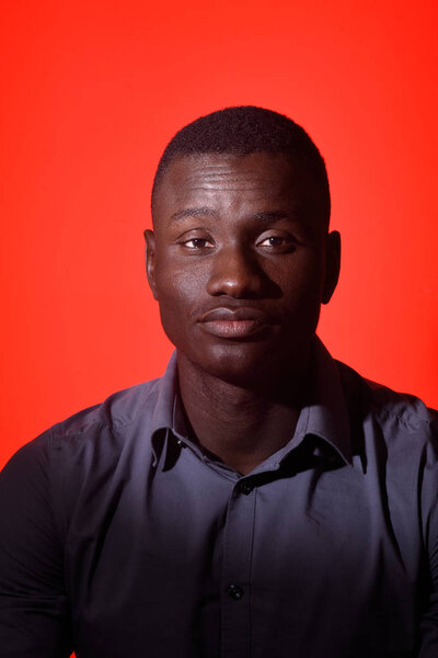 Portrait of a african man with eyes closed on red background