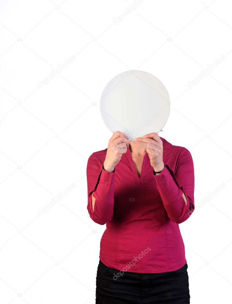a woman holding an empty plate in front of her face