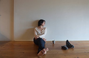 üzgün bir kadın evinin ahşap zemin üzerinde