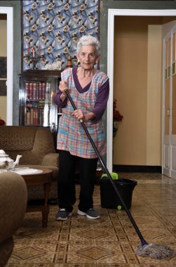 Onun evin katında yapım paspas ile yaşlı kadın