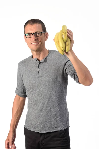 Homem com banana no fundo branco — Fotografia de Stock