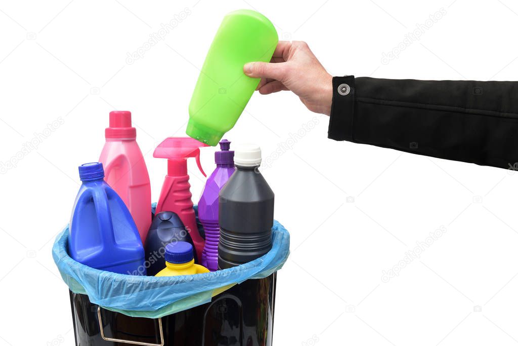 hand put a plastic bottle in a recycling bin