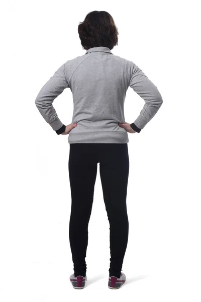 Rear view of a woman with sportswear and hands on hips on white — Stok fotoğraf