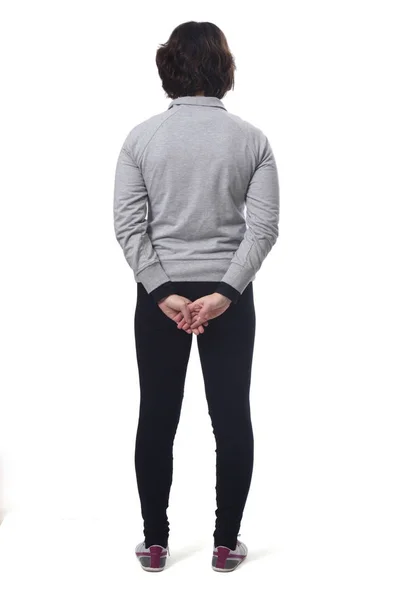 Rear view of a woman with sportswear and arms crossed on white b — 스톡 사진