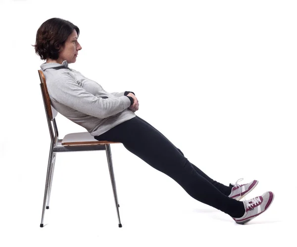 Portrait of a woman sitting on a chair in white background, rela — Stok fotoğraf