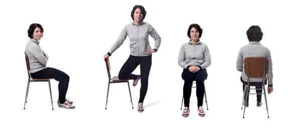 Porträtt av en kvinna som sitter på en stol i vit bakgrund — Stockfoto