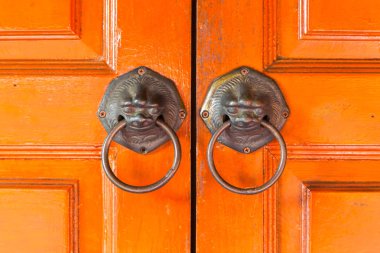 Lions'un kolları geleneksel Çince kapıya asmak.