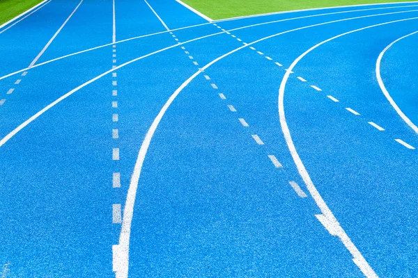 Athletics stadium running track blue lines marks.