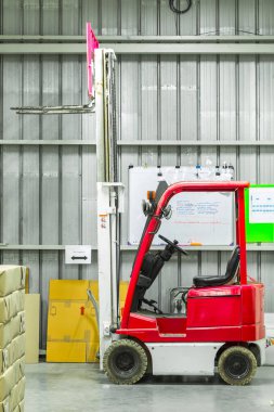 Forkliftlerle dolu modern bir depo.