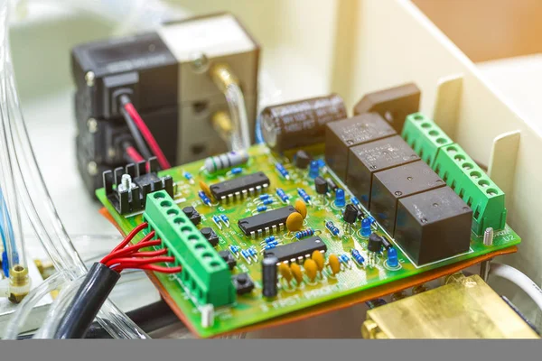 Integrated semiconductor microchip/ microprocessor on green circuit board representative of the high tech industry and computer science.