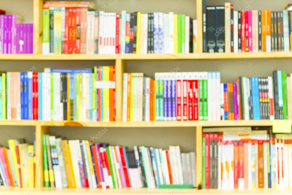 Books on bookshelf in library room, abstract blur de focused bac