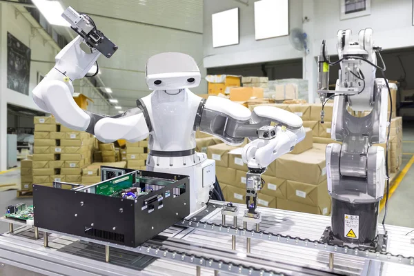 Industrial robot installing a computer chip in production line m — Stock Photo, Image