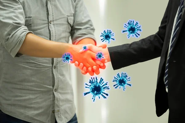 Covid-19 and Coronavirus ,Virus in hands concept.Business people shaking hands traditional in Europe with coronavirus.Concept for wash hands first. Covid19 coronavirus and pandemic virus symptoms.