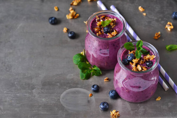 Berry yogurt with bran and oatmeal on a metal background
