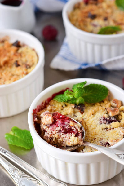 Crumble with berries, oatmeal and nuts on a metallic background