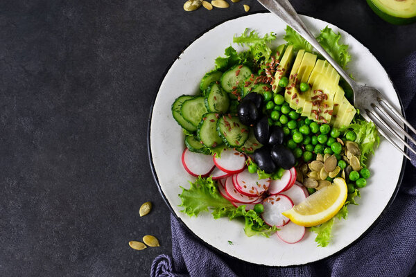 Vegan vegetable salad with flax seeds and olives