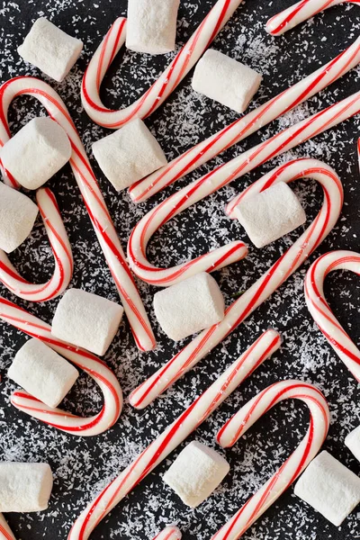 New Year\'s food background. Candy canes and marshmallow