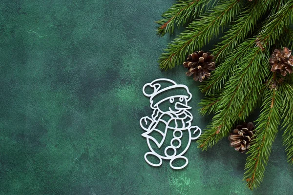 New year green background. New Year decoration with a snowman.