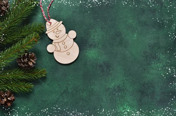 New year green background. New Year decoration with a snowman.
