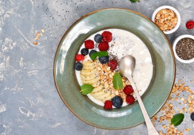 Yoğurt chia tohum, muz, yaban mersini ile bir tabak içinde 