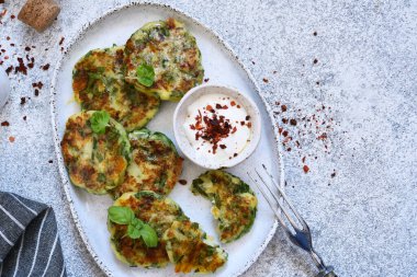 Green vegetarian cutlets with spinach on a concrete background.