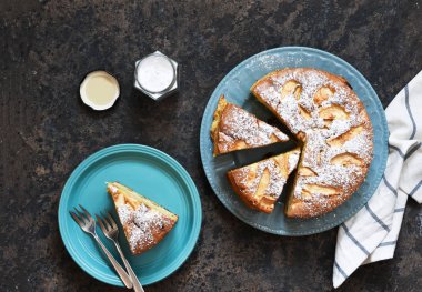 Charlotte - a classic pie with apples on a concrete background.