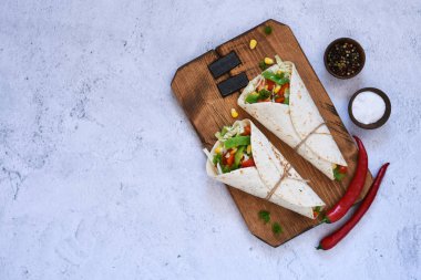 Tortilla with vegetable filling with chili pepper and sauce.
