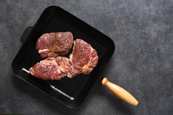 The process of cooking beef steak in a grill pan with spices. — Stock Photo, Image