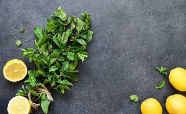 Siyah arka planda limon ve nane karışımı. Limonata malzemesi..