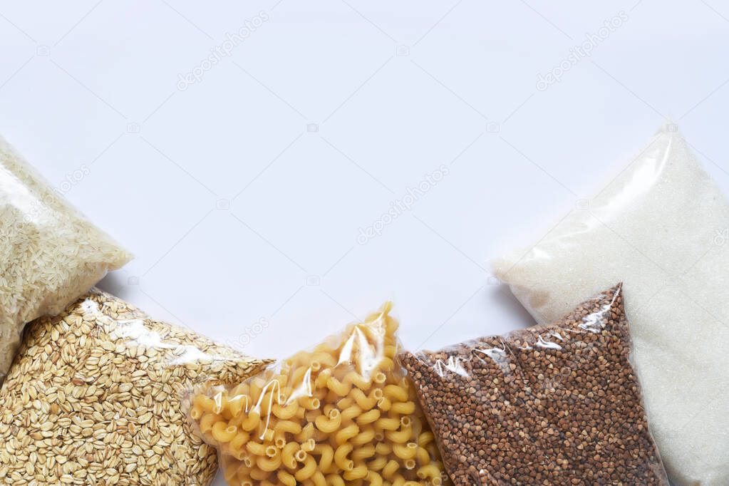 Food supplies crisis food stock for quarantine on white background. Pasta, buckwheat, sugar, rice. Donation. Top view