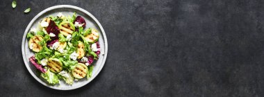 Salata ile ızgara kabağı ve sosu siyah arka planda karıştır. Üst manzara ve fotokopi alanı..