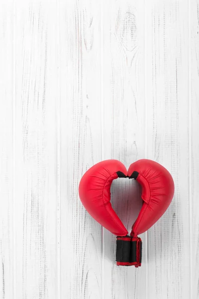 red gloves for karate lie on a wooden white background