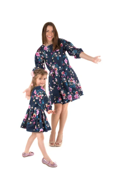 母亲与女儿在相同的礼服跳舞和微笑 — 图库照片